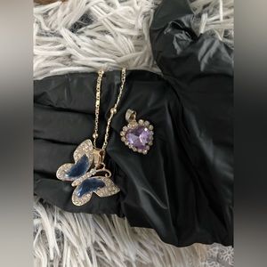 Gold necklace with blue butterfly and purple heart pendant